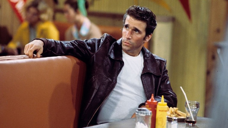 Henry Winkler sitting in Happy Days