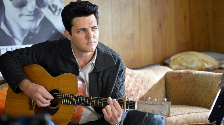 Blake Rayne playing guitar as Elvis in The Identical