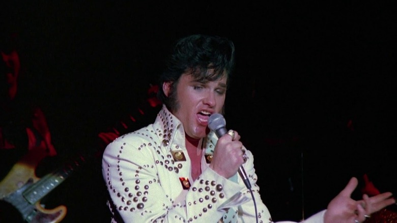Kurt Russell performing on stage as Elvis in Elvis