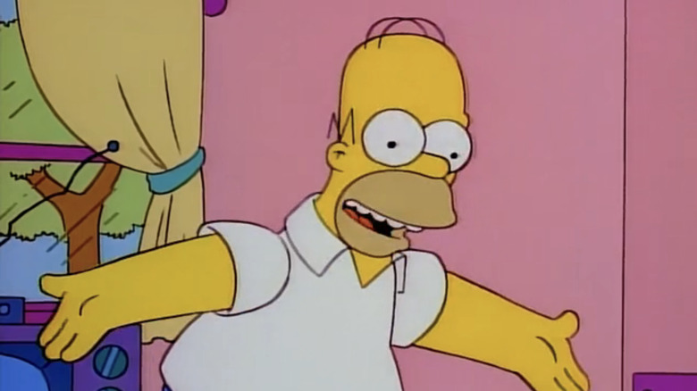 Homer SImpson stands in his living room with his arms held wide in The Simpsons