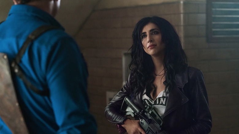 Dana DeLorenzo holding rifle