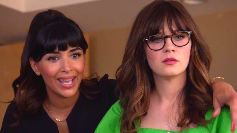 Hannah Simone with arm around  Zooey Deschanel