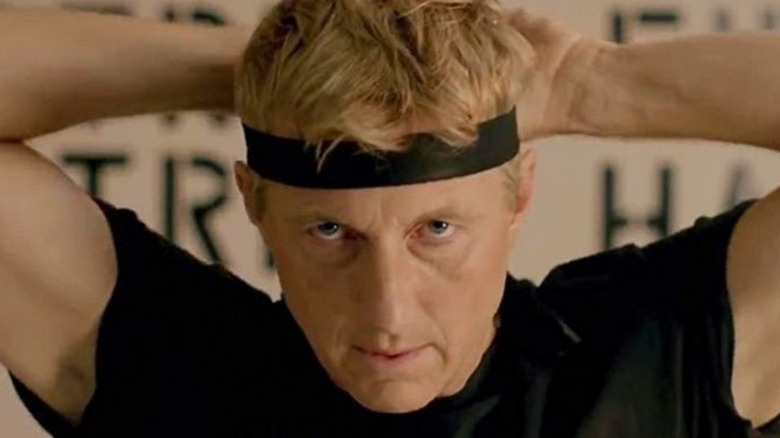 Johnny ties his headband in Cobra Kai