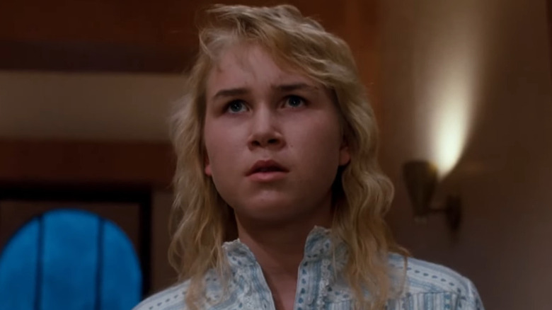 Jennifer walks towards the television