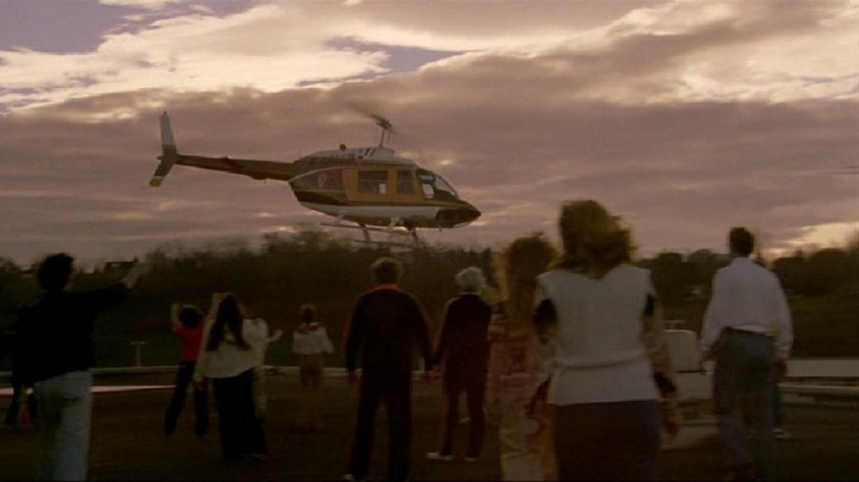 Zombies chase a helicopter
