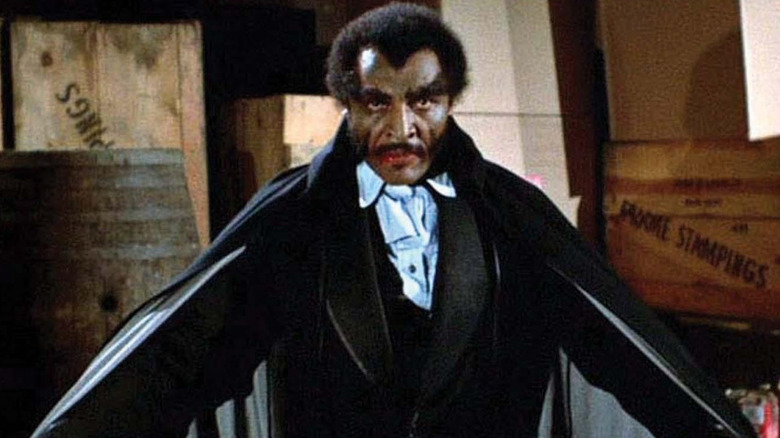 Blacula holds open his cape in Blacula