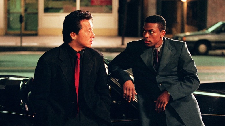 Lee (Jackie Chan) leans on a car looking at James Carter (Chris Tucker) in Rush Hour