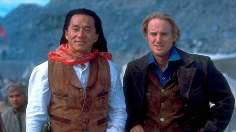 Chon Wang (Jackie Chan) smiles next to Roy O'Bannon (Owen Wilson) in Shanghai Noon