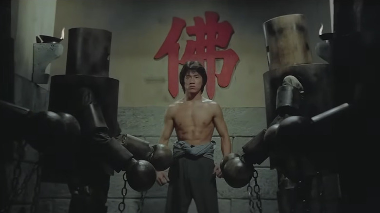 Little Mute (Jackie Chan) enters the hallway of wooden fighters in Shaolin Wooden Men