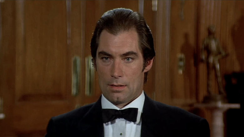 Timothy Dalton's James Bond sits in a wood panelled room in Licence to Kill