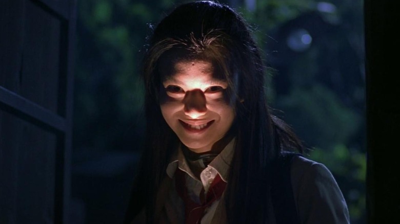 Ko Shibasaki smiling with flashlight raised to chin