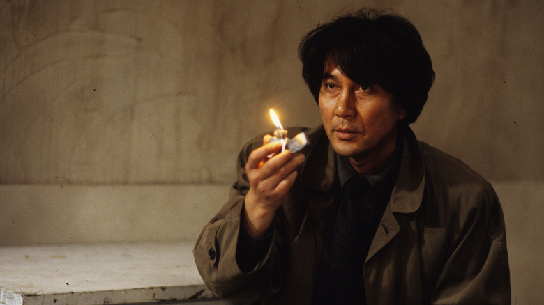 Cure detective holds lighter