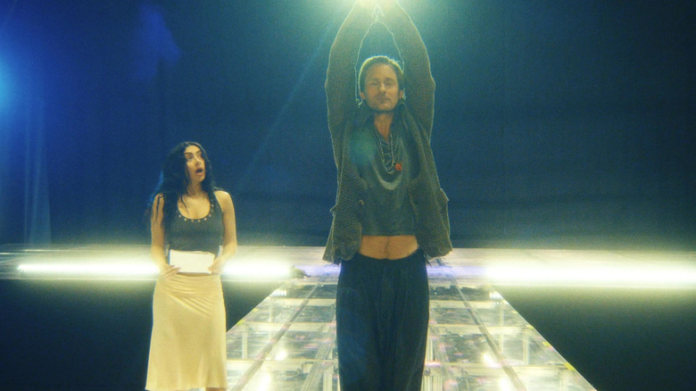 Charli XCX watches as Johannes Godwin demonstrates how she should perform in The Moment