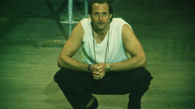 Johannes Godwin squats to get a better look at his masterpiece in The Moment