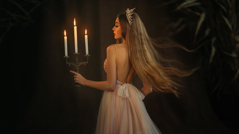 Medieval princess holding candles
