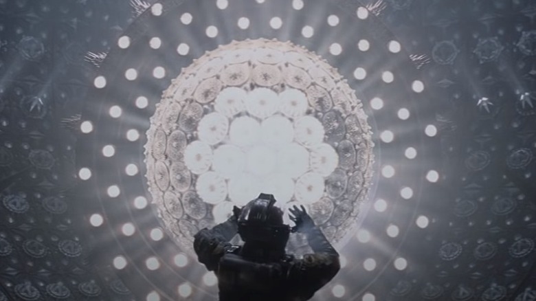 Figure in spacesuit glowing orb