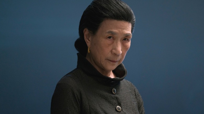 Madame Gao stares forbiddingly.