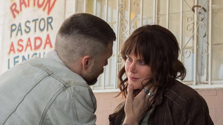 Chris holding Erin Bell's face affectionately