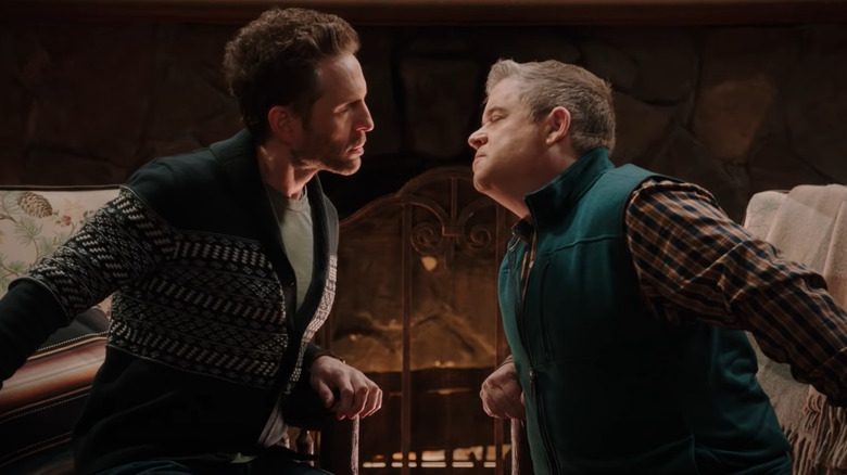 Glenn Howerton and Patton Oswalt leaning in for a romantic kiss