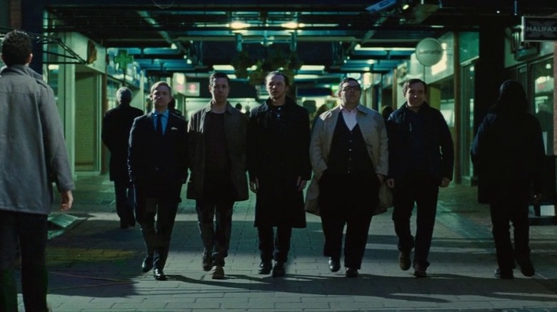 Five men walking side by side
