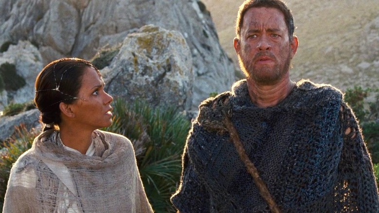 Halle Berry as Meronym stands next to Tom Hanks as Sachry outside in Cloud Atlas