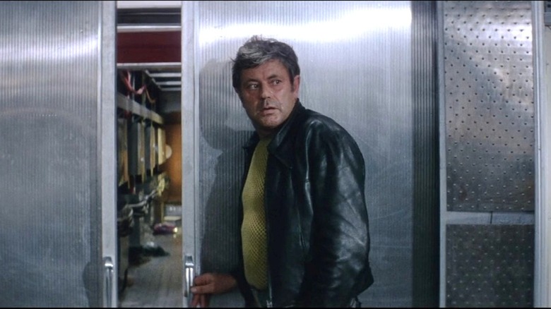 Donatas Banionis as Kris Kelvin looks to the right while holding a door on a space station in Solaris