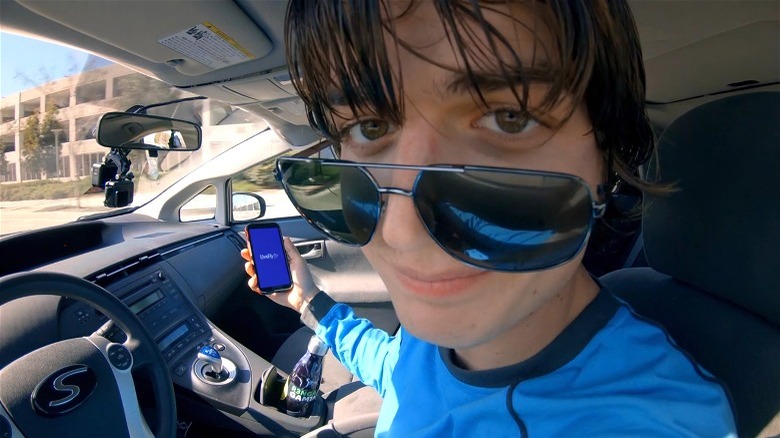 Fish-eye view of Joe Keery Spree sunglasses down on nose