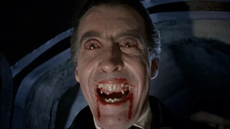 Dracula (Christopher Lee), with bloodshot eyes, bares his bloody fangs in Dracula (1958)