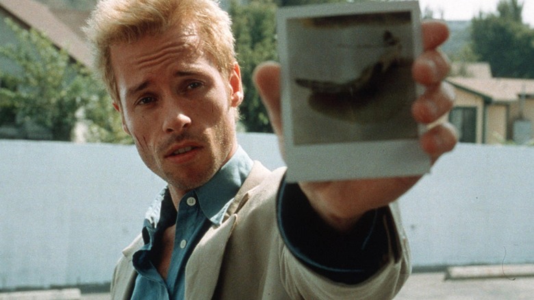 Guy Pearce holds up picture