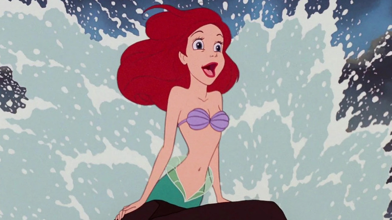 Ariel singing as a wave splashes behind her in The Little Mermaid