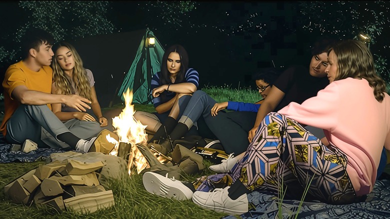 A group of camps sitting around the fire 