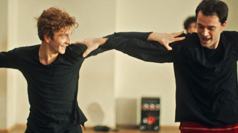 Merab and Irakli holding arms and dancing