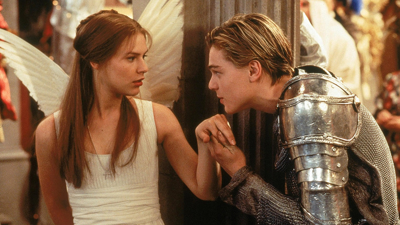 Romeo in knight costume holding winged Juliet's hand