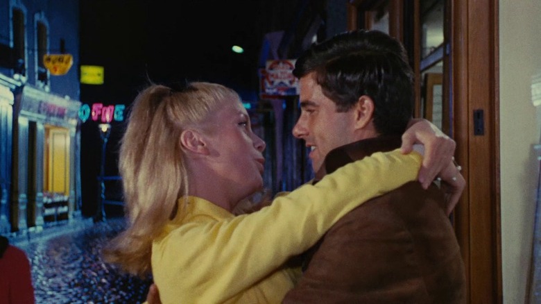 Geneviève with arms wrapped around Guy