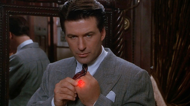 Lamont Cranston (Alec Baldwin) adjusting his tie in "The Shadow."