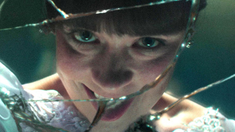 The demon version of Judy peers back through the glass in The Conjuring: Last Rites