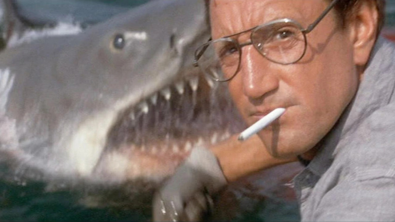 Roy Scheider as Brody looking away as the shark pops out of the water in Jaws