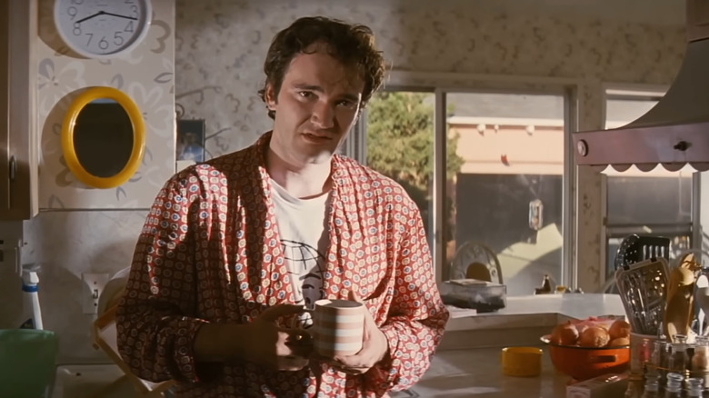 Pulp Fiction, Quentin Tarantino playing Jimmy, talking in his kitchen in a robe holding coffee