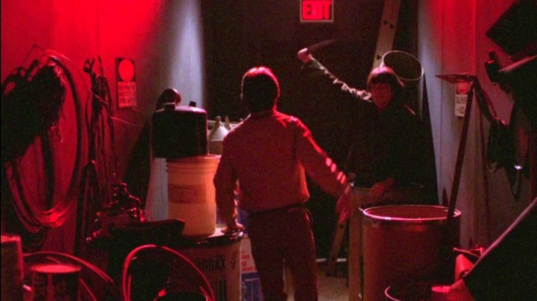 A College student is attacked by a knife wielding killer in a basement littered with objects