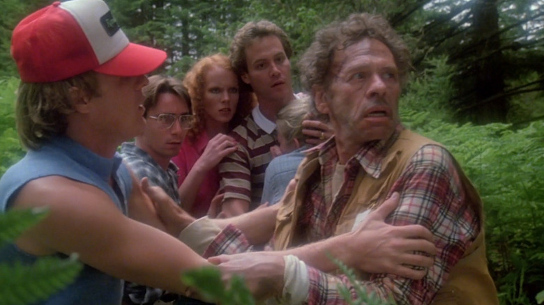A group of teens question a scared man in the woods