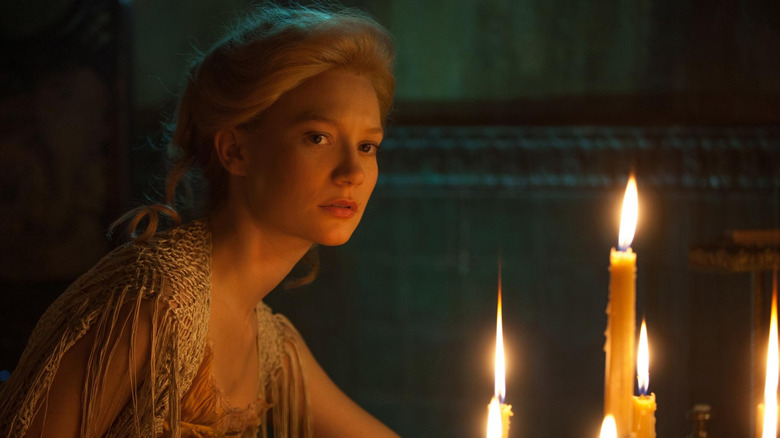 gothic woman with candelabra in Crimson Peak