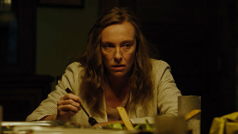 women sitting at dinner table in fear