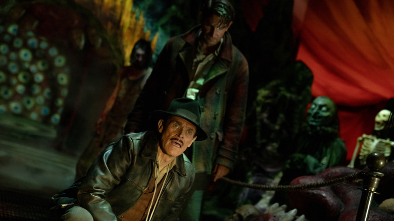 Willem Dafoe (foreground) and Bradley Cooper star in Nightmare Alley (2021)