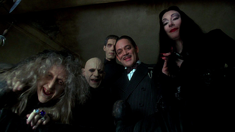 The Addams Family peers down at baby Pubert in Addams Family Values