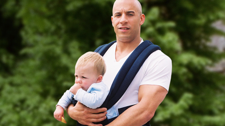 Vin Diesel carries a baby
