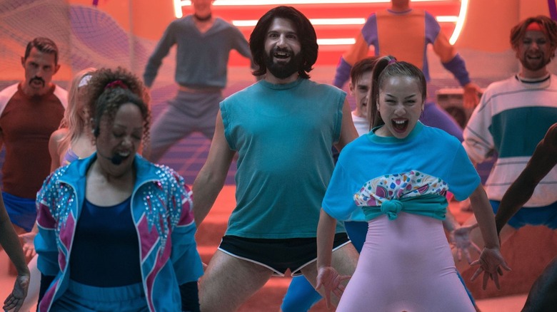 Nandor, dressed in workout clothes, participates in an aerobics class with other vampires