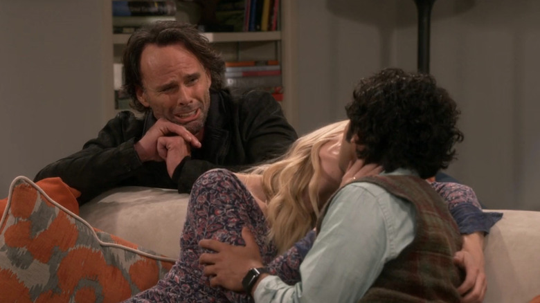 Walton Goggins as Oliver watching Raj kissing a woman on the couch
