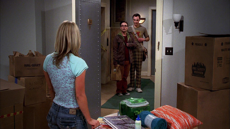 Penny unpacking her apartment with Leonard and Sheldon