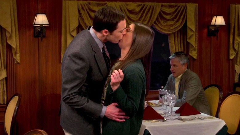 Sheldon and Amy kissing on a train on The Big Bang Theory