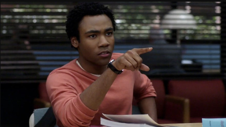 Donald Glover as Troy Barnes on Community pointing in defense of the Barenaked Ladies